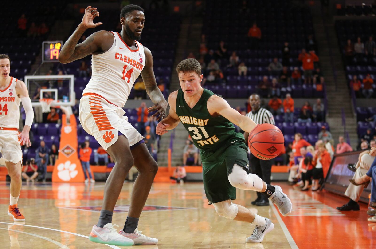 Wright State’s Cole Gentry (31) dribbles down the sideline against Clemson’s Elijah Thomas (14) during Tuesday night’s NIT game at Littlejohn Coliseum in Clemson, S.C. Clemson won 75-69. PHOTO COURTESY OF CLEMSON ATHLETICS