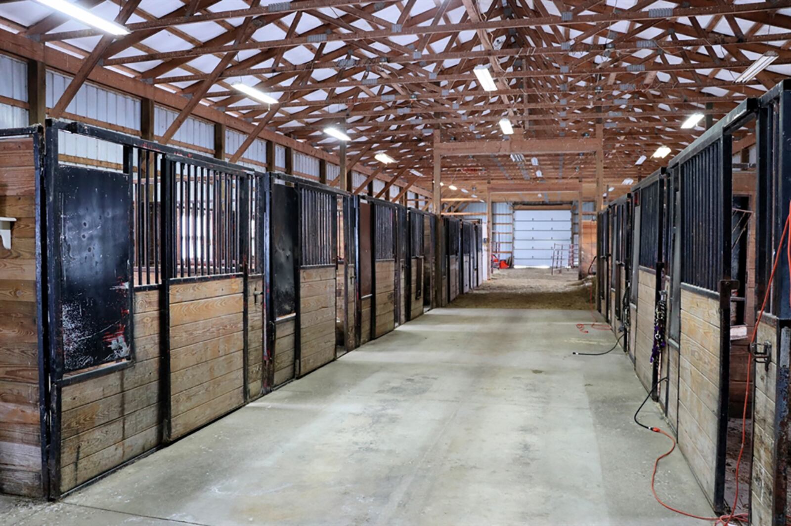 At the center of the property is a 50-by-38-foot metal barn with 11 stalls, a wash room, tack room, concrete and dirt floors and two large overhead doors. The barn has electric and access to the training area and livestock pasture with feed shelter. CONTRIBUTED PHOTO BY KATHY TYLER