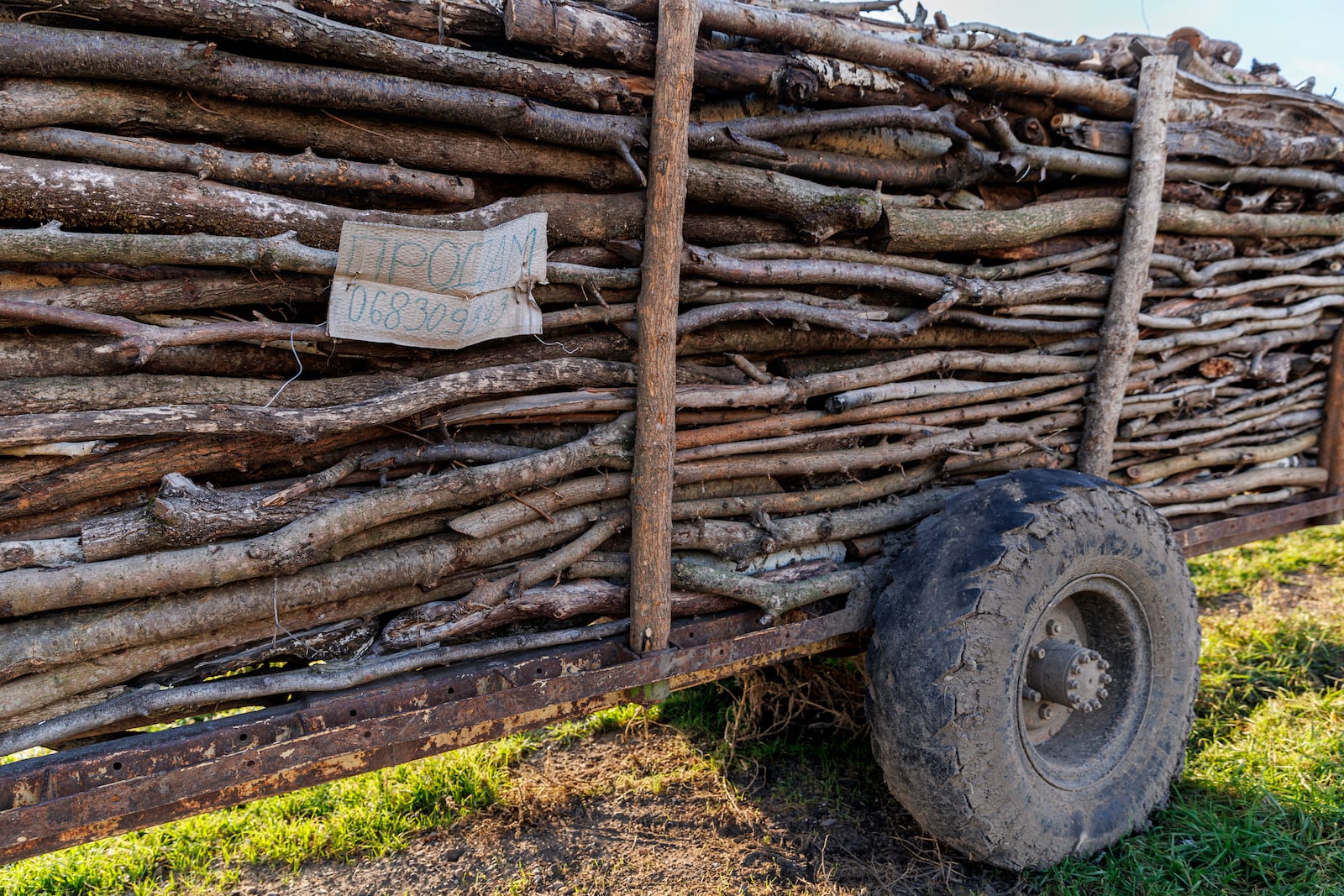 A trailer with fire wood for sale is parked on the side of the road in Copanca, Moldova, Wednesday, Jan. 8, 2025. (AP Photo)