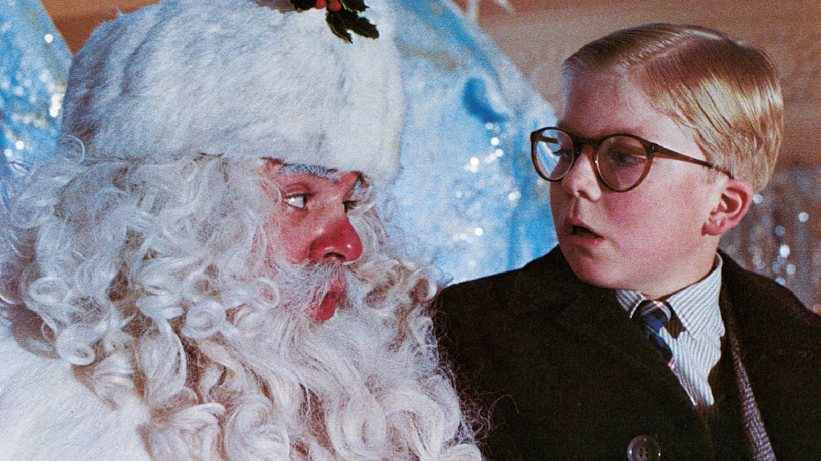 Peter Billingsley sits on Santa's lap in a scene from the film 'A Christmas Story', 1983.