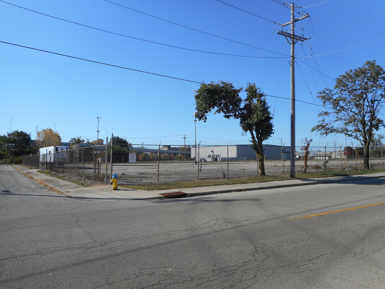 The Foodbank’s site (left) has made a lot of out of a former industrial site (a “before” image shown at right), transforming it into a space with vegetable gardens, trees and even pollinator habitat (as seen in the background of the left photo). CONTRIBUTED