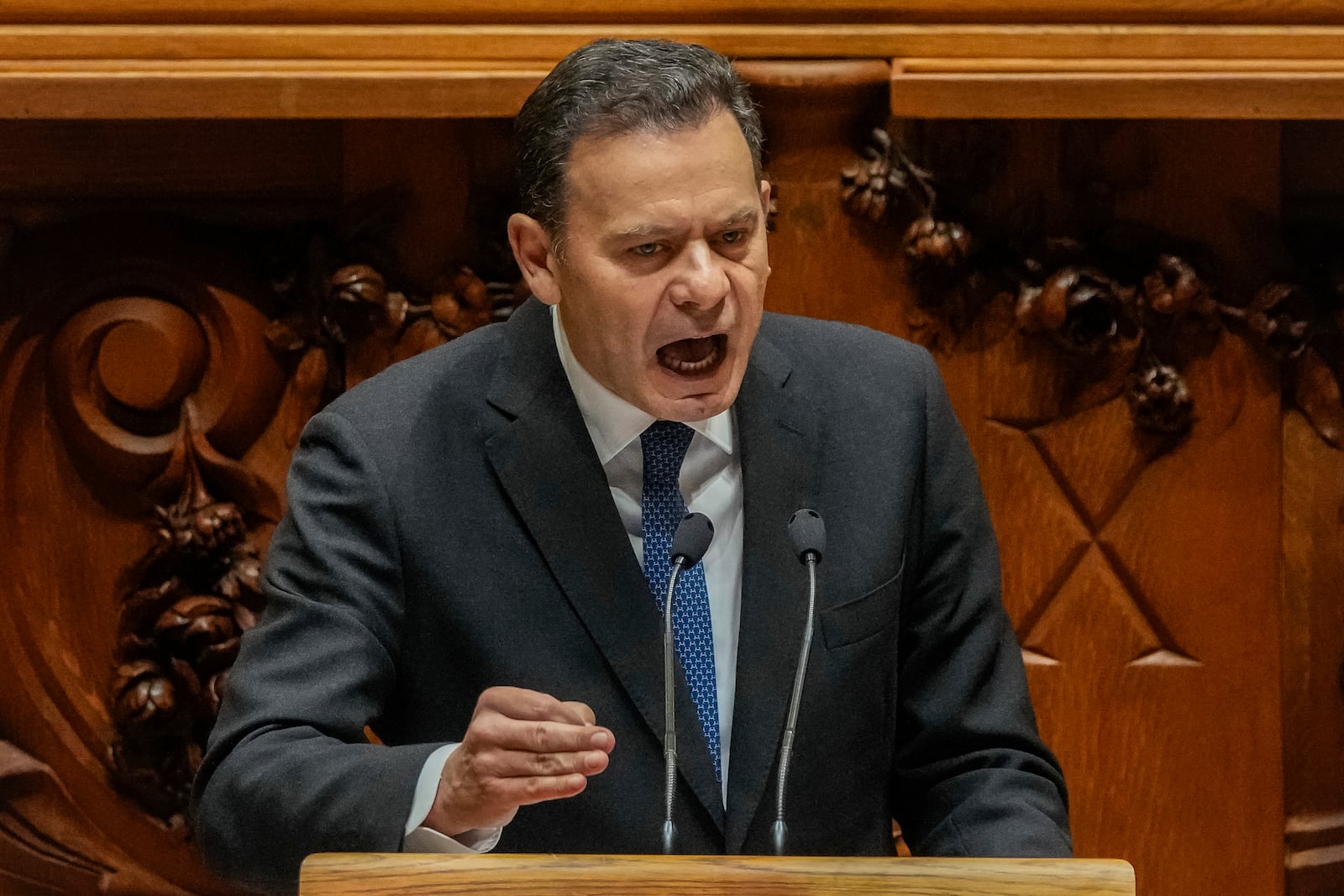 Portuguese Prime Minister Luis Montenegro gives a speech at the start of a debate preceding the vote on a confidence motion at the Portuguese parliament in Lisbon, Tuesday, March 11, 2025. (AP Photo/Armando Franca)