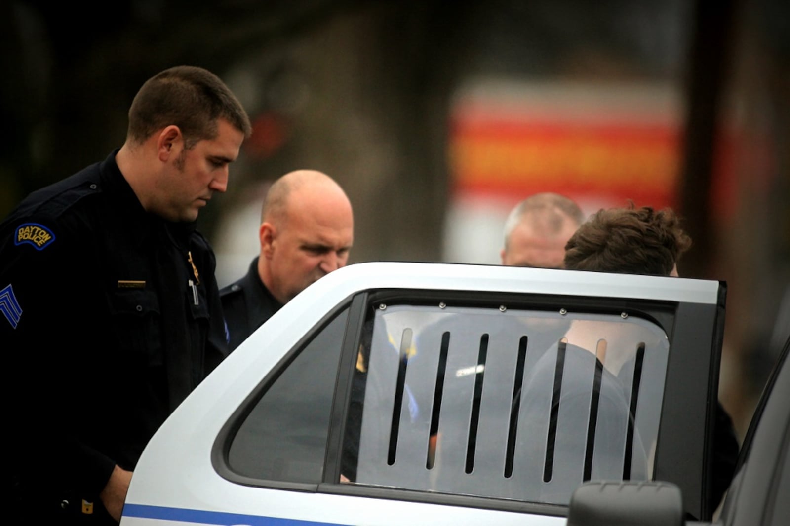 Dayton police arrested two young men Wednesday afternoon, Nov. 30, 2016, who ran from police. Here, one of the runners is being placed in a police cruiser. (Jim Noelker/Staff)