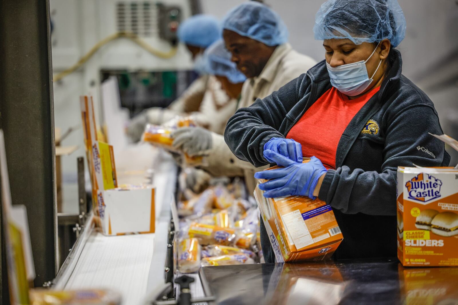 Employees at the White Castle Vandalia plant box up hundreds of thousands of Slider hamburgers each day. JIM NOELKER/STAFF