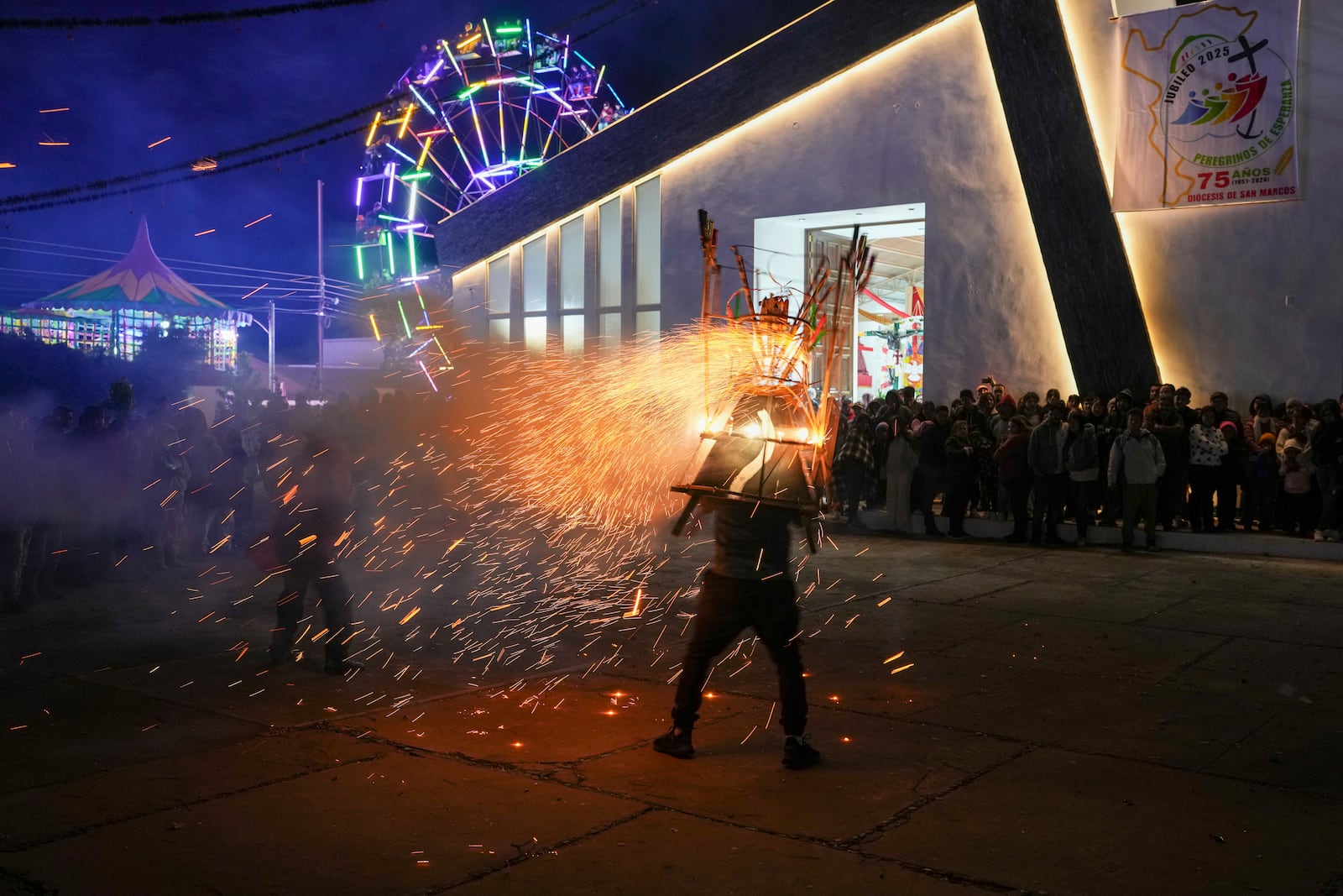 A man wears a "torito" fireworks display during the celebration of the Black Christ of Esquipulas the night before its feast day in Esquipulas Palo Gordo, in Guatemala's San Marcos department, Tuesday, Jan. 14, 2025. (AP Photo/Moises Castillo)