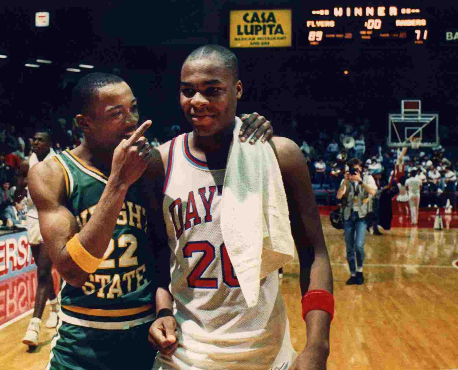 Wright State’s Joe Jackson walks off the court with Dayton’s Anthony Corbitt after the first Gem City Jam game on March 5, 1988, at UD Arena. DDN FILE PHOTO