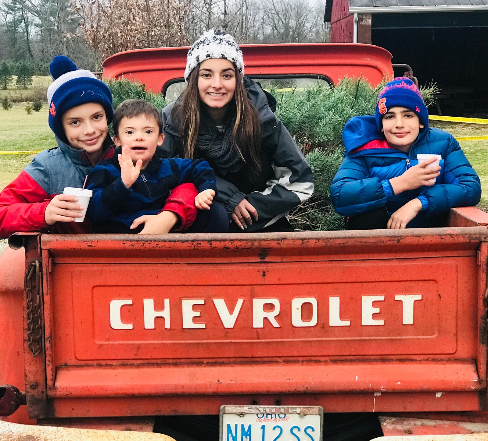 The Holzberg family of Oakwood were recently surprised by the support of their family and friends when they received $18,000 in donations to help their youngest son George (second from left) get a service dog. George has Down syndrome. From left are Leo, George, Helen and Lewis. CONTRIBUTED