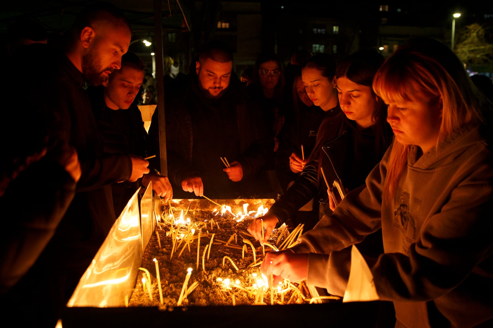 People light candles in the town of Kocani, North Macedonia, Sunday, March 16, 2025, following a massive fire in a nightclub early Sunday. (AP Photo/Visar Kryeziu)