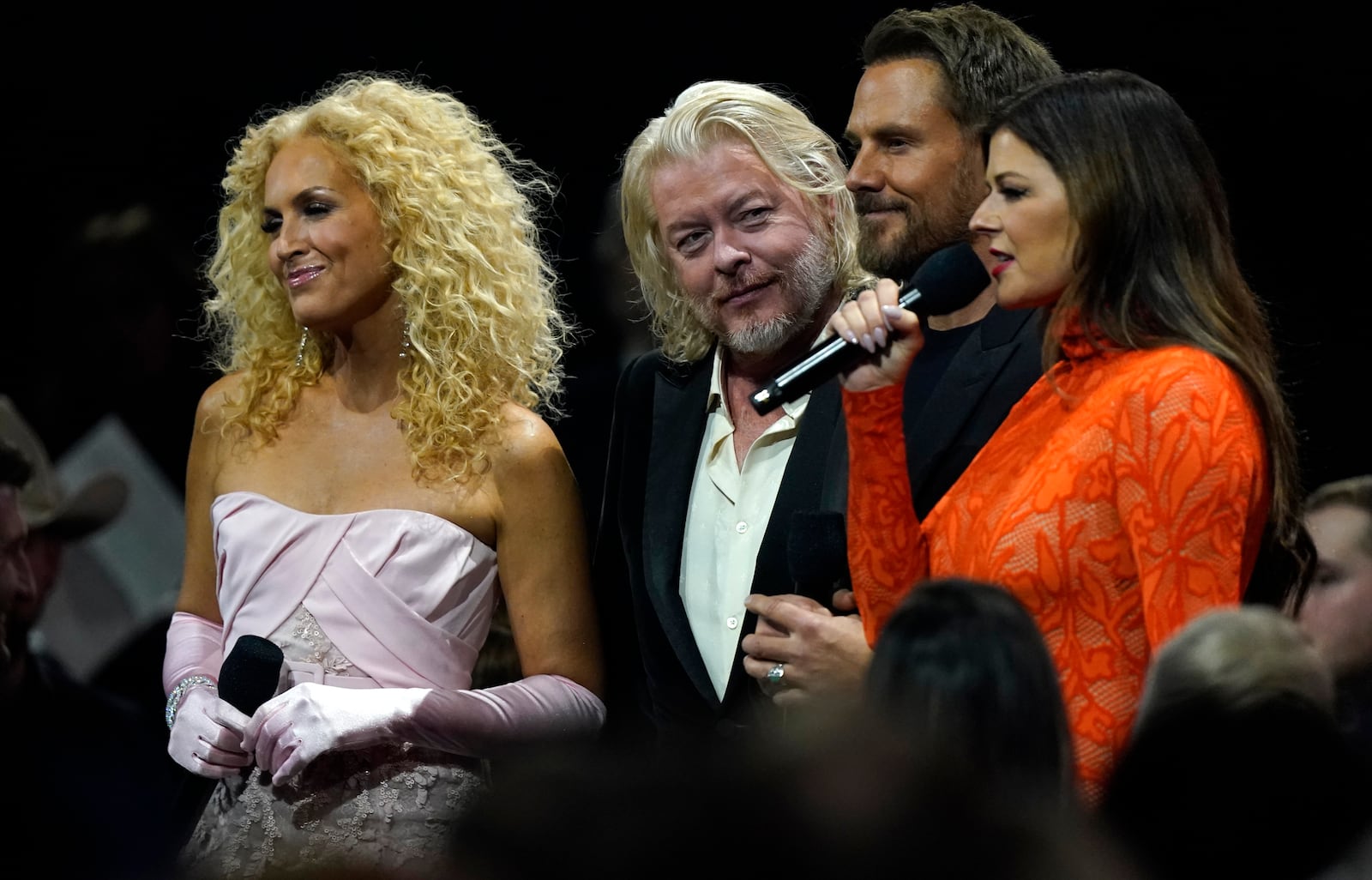 Kimberly Schlapman, from left, Philip Sweet, Jimi Westbrook and Karen Fairchild, of Little Big Town, present the award for vocal duo of the year during the 56th Annual CMA Awards on Wednesday, Nov. 9, 2022, at the Bridgestone Arena in Nashville, Tenn. (AP Photo/Mark Humphrey)