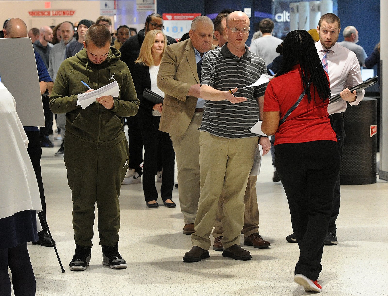 Job seekers sign up inside UD Arena, Thursday, April 25, 2024 for the Spring job fair hosted by the Montgomery County Workforce Development. Job seekers had the opportunity to meet with nearly 150 local employers. MARSHALL GORBY\STAFF