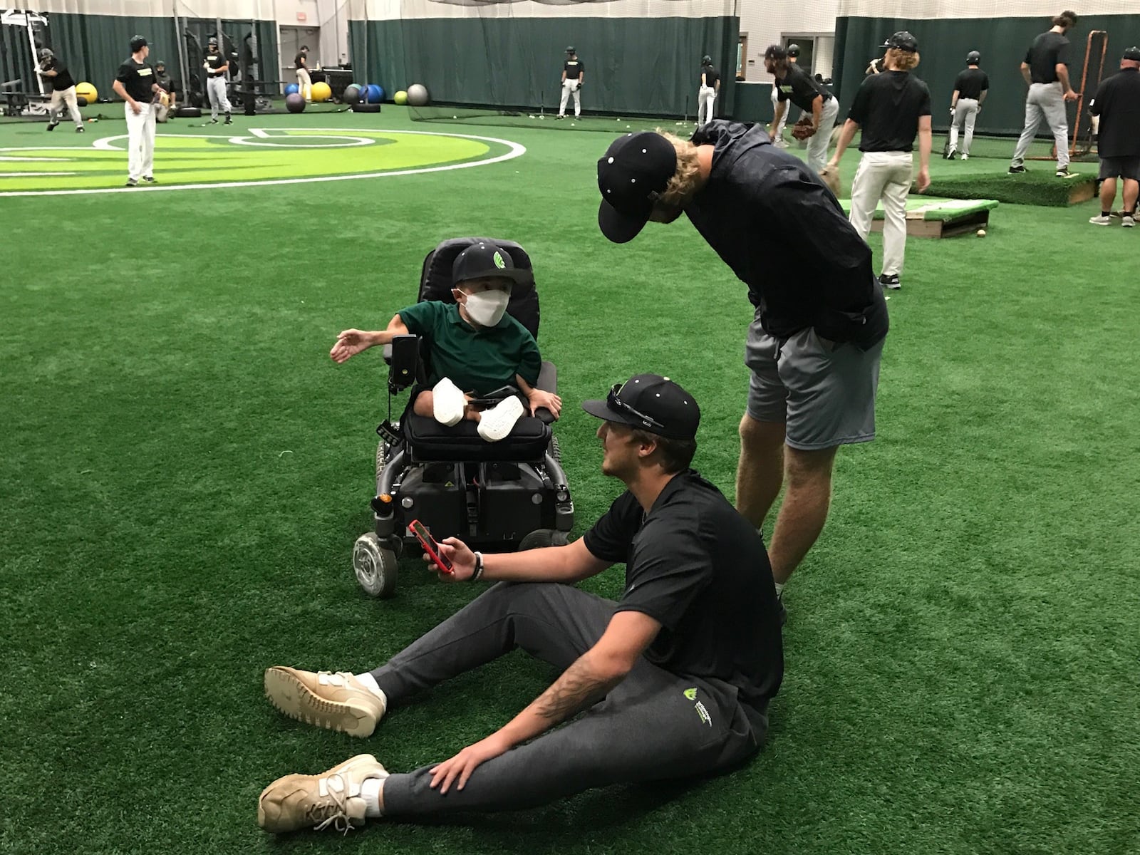 Wilmington assistant baseball coach Daniel “Danny “ McCarty talks to freshman pitcher Mason Hornung (standing) from Liberty, Ind., and sophomore first baseman/outfielder Griffn McCauley, of Columbus, during an indoor practice in September 2021. Photo by Tom Archdeacon