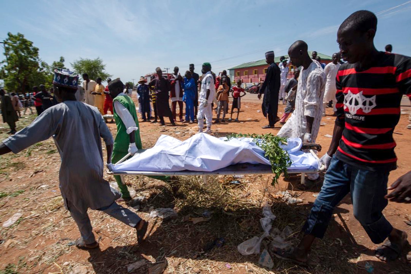 People carry the body of a victim of a tanker explosion for funeral in Majiya town, Nigeria, Wednesday, Oct. 16, 2024. (AP Photo/Sani Maikatanga)