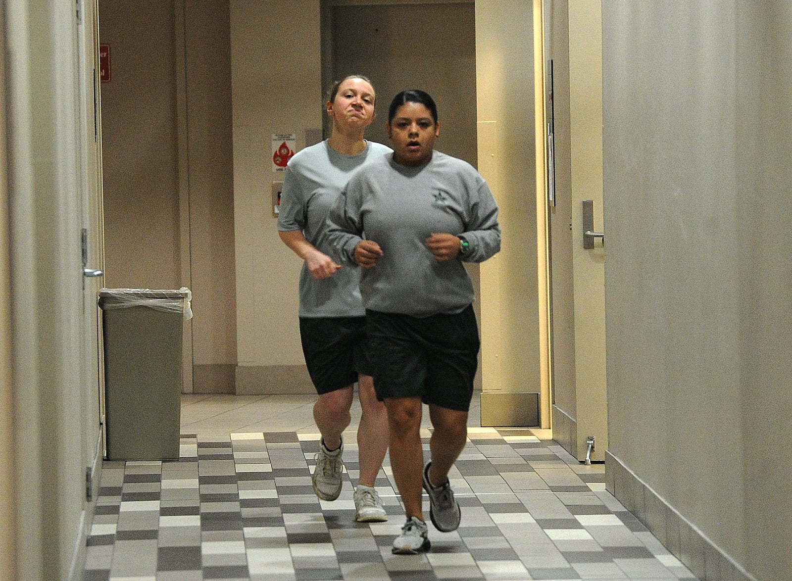 Cadet Vivian Litzinger and reporter London Bishop, in back, run a circuit through the halls at Sinclair Community College, Thursday, Jan. 11, 2024. MARSHALL GORBY\STAFF