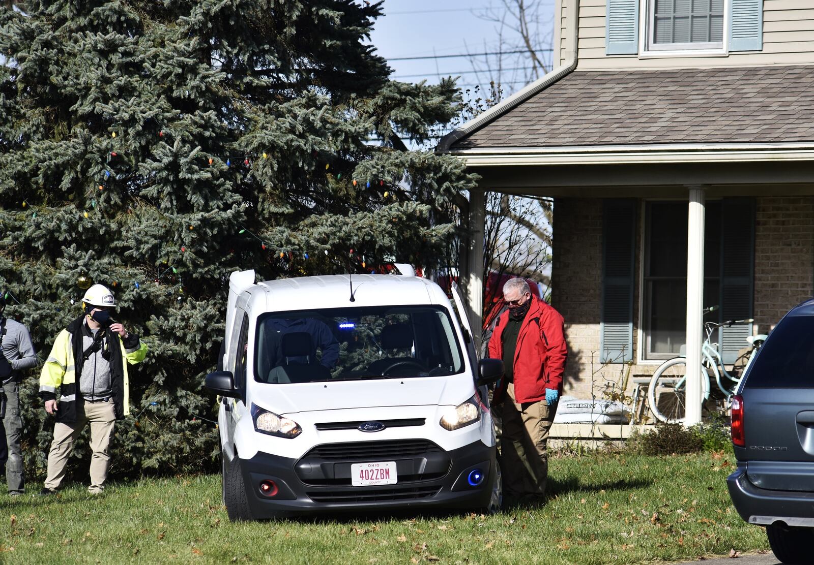 Emergency units work to remove a truck that slammed into a Monroe house this morning NICK GRAHAM/STAFF