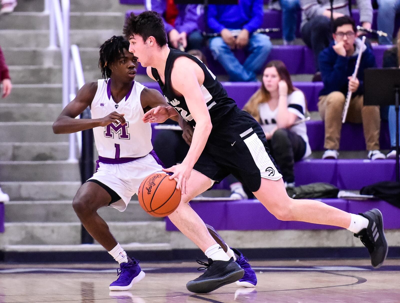 Lakota East’s Bash Wieland dribbles to the basket defended by Middletown’s Jayden Jackson during their game Jan. 8 at Middletown’s Wade E. Miller Arena. East won 61-47. NICK GRAHAM/STAFF