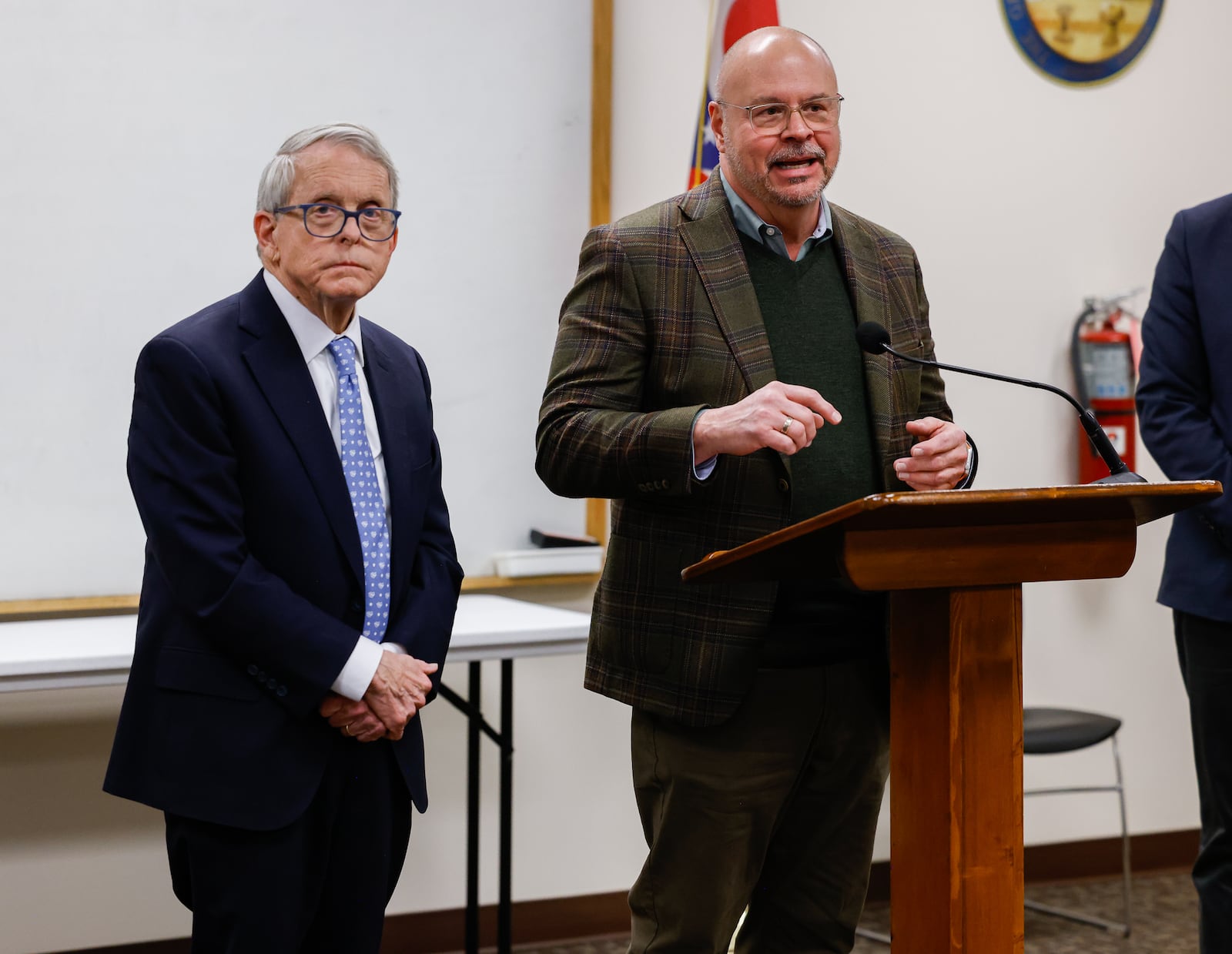 Gov. Mike DeWine, left, listens while Jim Chakeres. right, an executive vice president for the Ohio Poultry Association, talks during a press conference on Thursday afternoon in Versailles.