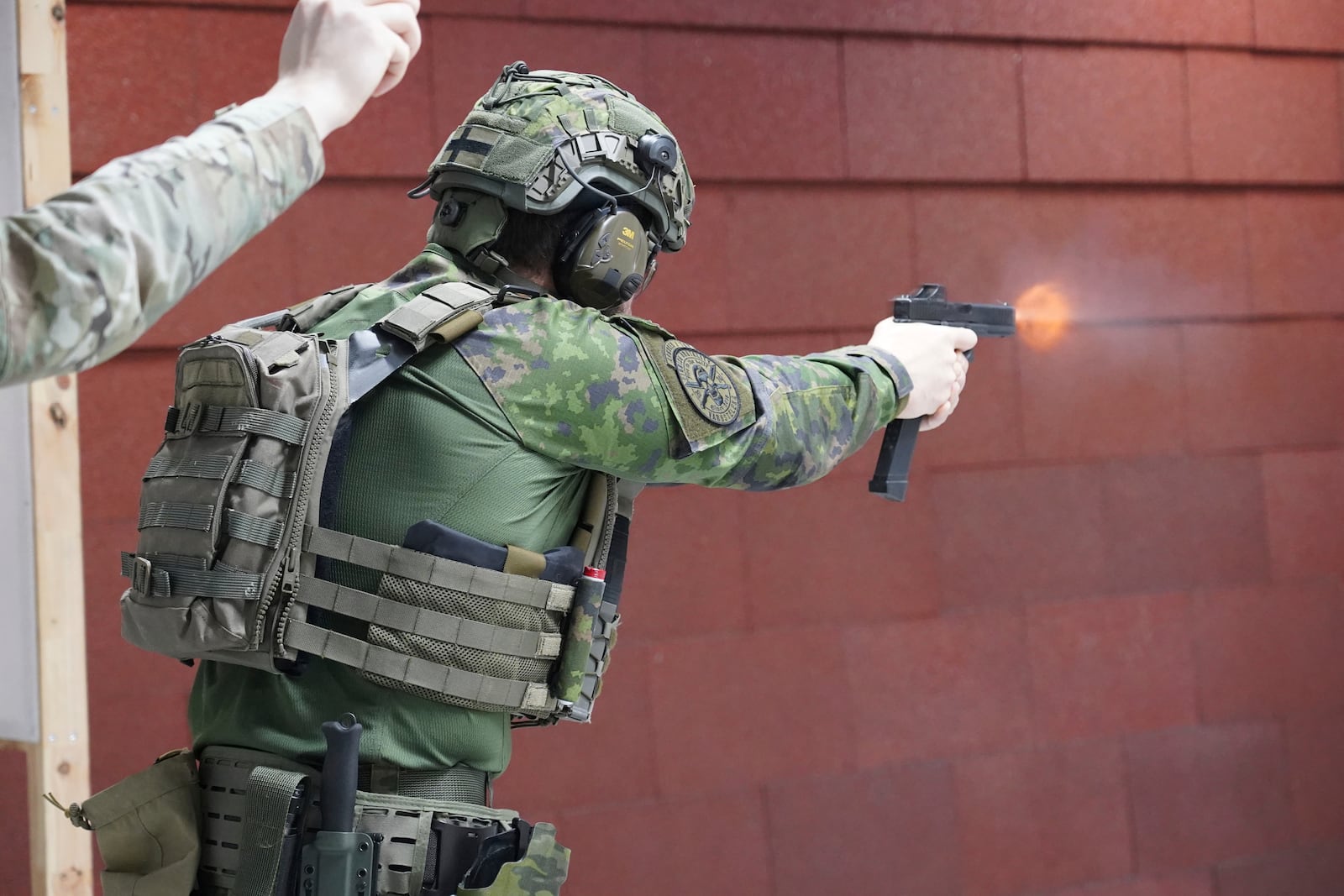 Members of the Vantaa Reservists Association practice at a shooting range in a warehouse in Kerava on the outskirts of Helsinki, Finland Monday, Dec. 2, 2024. (AP Photo/James Brooks)