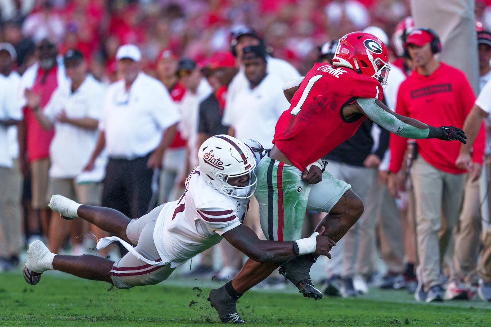 Georgia running back Trevor Etienne (1) is tackled by Mississippi State safety Jordan Morant (17) during an NCAA college football game, Saturday, Oct. 12, 2024, in Athens, Ga. (AP Photo/Jason Allen)