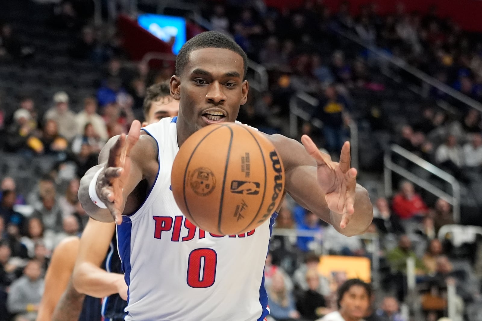 Detroit Pistons center Jalen Duren (0) reaches for the loose ball during the first half of an NBA basketball game against the Orlando Magic, Wednesday, Jan. 1, 2025, in Detroit. (AP Photo/Carlos Osorio)