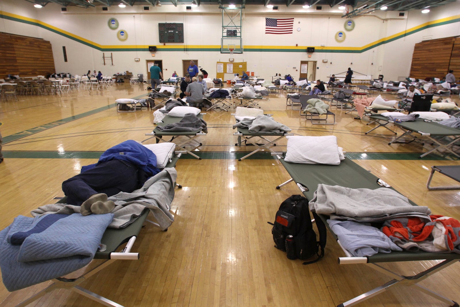 FILE- An evacuee sleeps on a cot at a temporary American Red Cross shelter at the Robert Ellis Young Gymnasium at Missouri Southern State University in Joplin, Mo., Monday, May 23, 2011. (AP Photo/Mark Schiefelbein, File)