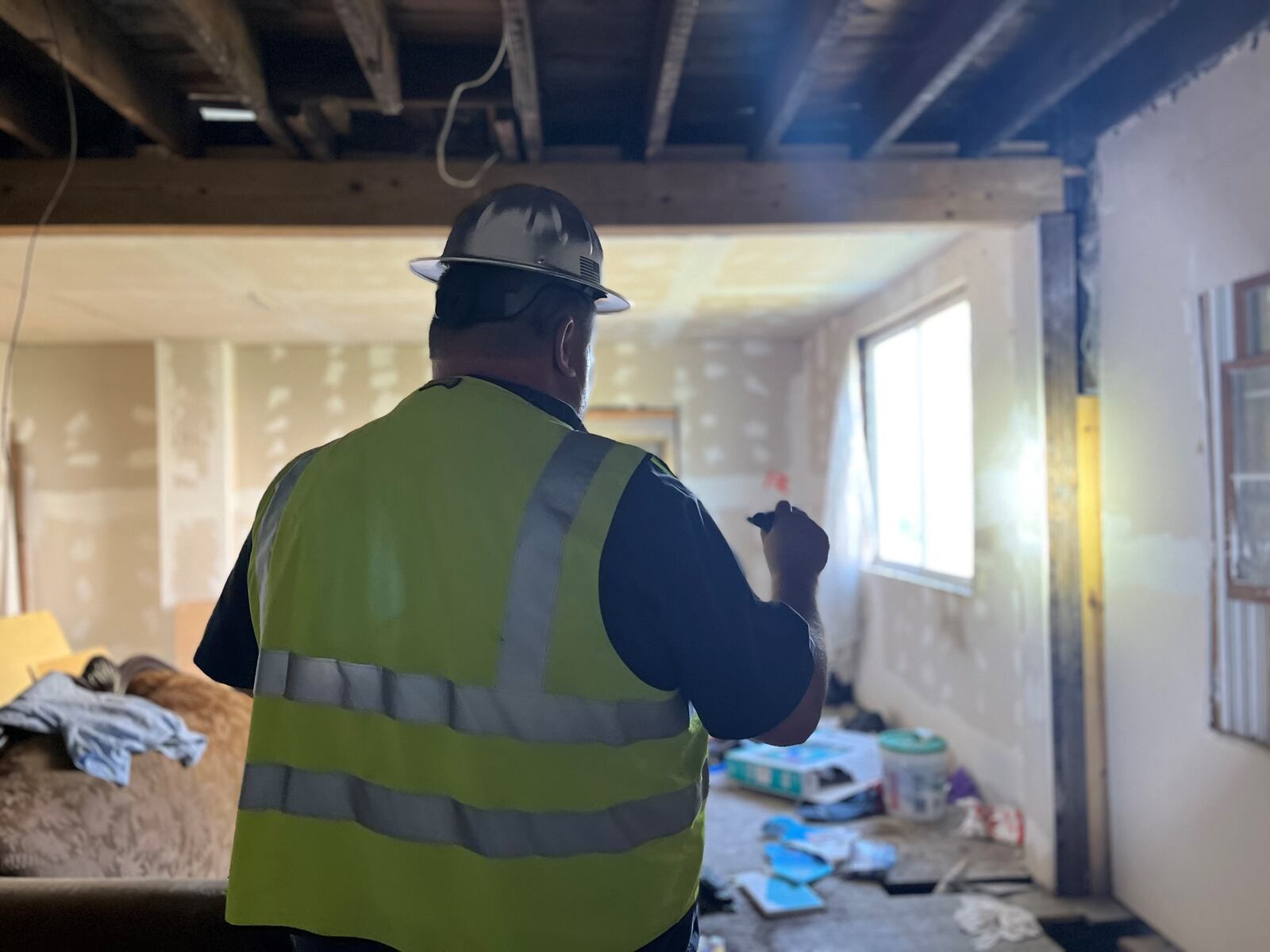 Ken Jackson, a city of Dayton nuisance abatement specialist, walks through a home on Chapel Street before its demolition on Tuesday, June 21, 2022. CORNELIUS FROLIK / STAFF