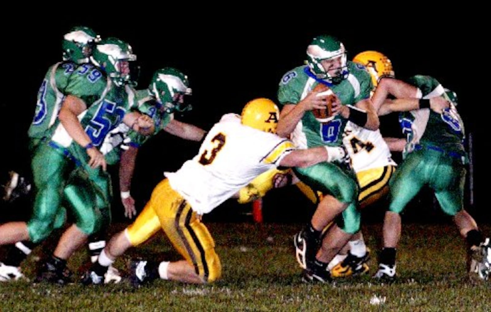 Alter senior Tim Cableck (3) goes after the Eagles Quarterback Kurt Hess (6) behind the line of scrimmage as the Chaminade-Julienne Eagles play the Alter High School Knights, Friday, October 26, 2007. PETER WINE / CONTRIBUTED