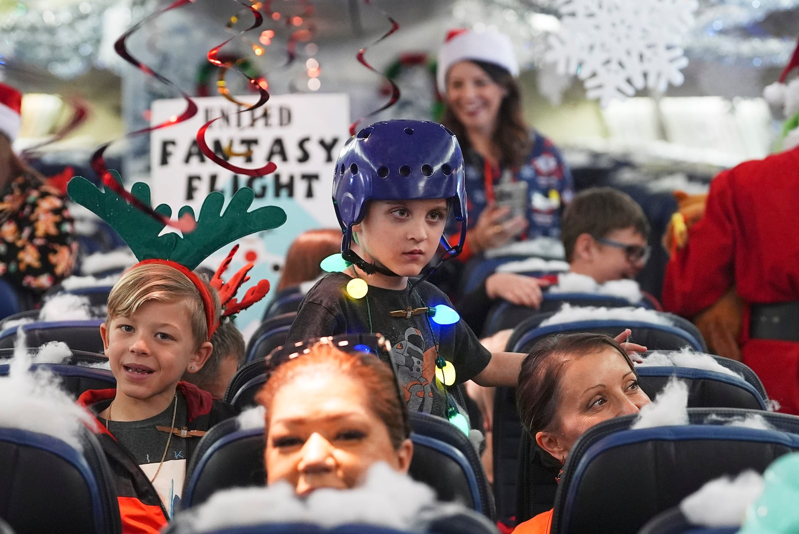 Participants prepare for take off during the United Airlines annual "fantasy flight" to a fictional North Pole at Denver International Airport, Saturday, Dec. 14, 2024, in Denver. (AP Photo/David Zalubowski)