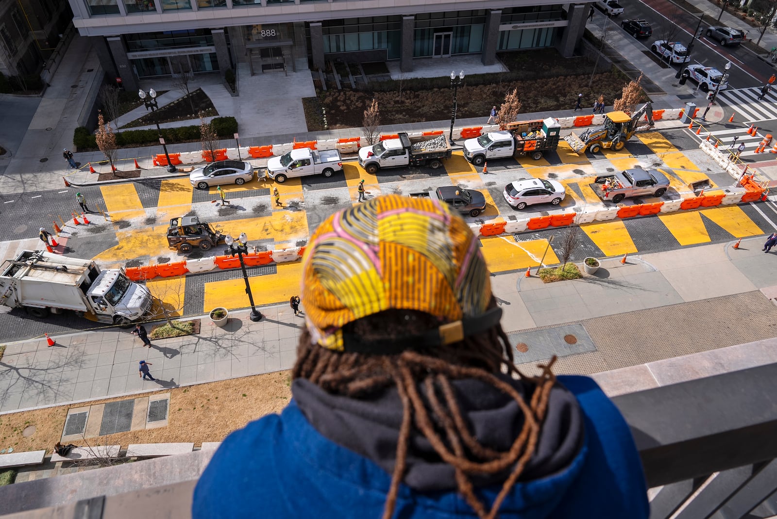 From the top of a building, Kanon Kennedy, of Washington, looks down at the Black Lives Matter mural as demolition begins, Monday, March 10, 2025, in Washington. (AP Photo/Jacquelyn Martin)