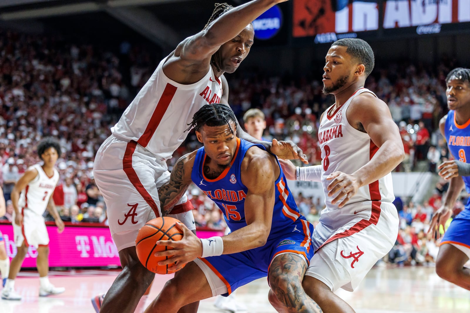 Florida guard Alijah Martin (15) works out of a double-team of Alabama center Clifford Omoruyi (11) and guard Chris Youngblood (8) during the first half of an NCAA college basketball game, Wednesday, March 5, 2025, in Tuscaloosa, Ala. (AP Photo/Vasha Hunt)