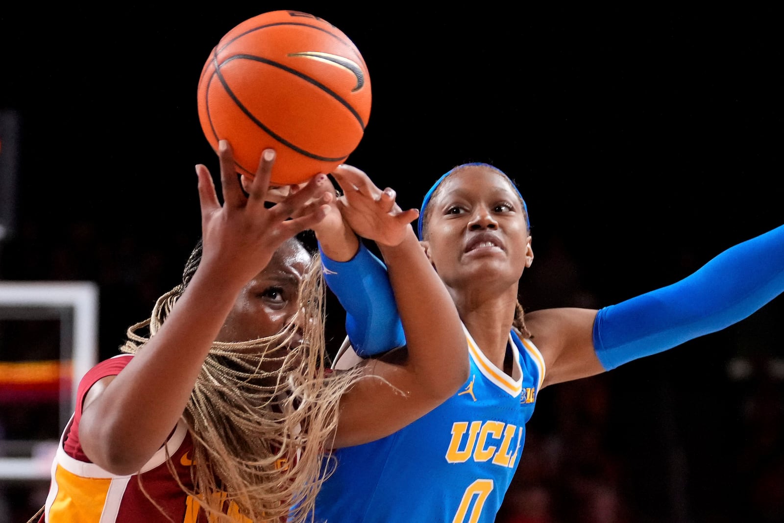 Southern California center Clarice Akunwafo, left, and UCLA forward Janiah Barker reach for the ball during the first half of an NCAA college basketball game, Thursday, Feb. 13, 2025, in Los Angeles. (AP Photo/Mark J. Terrill)