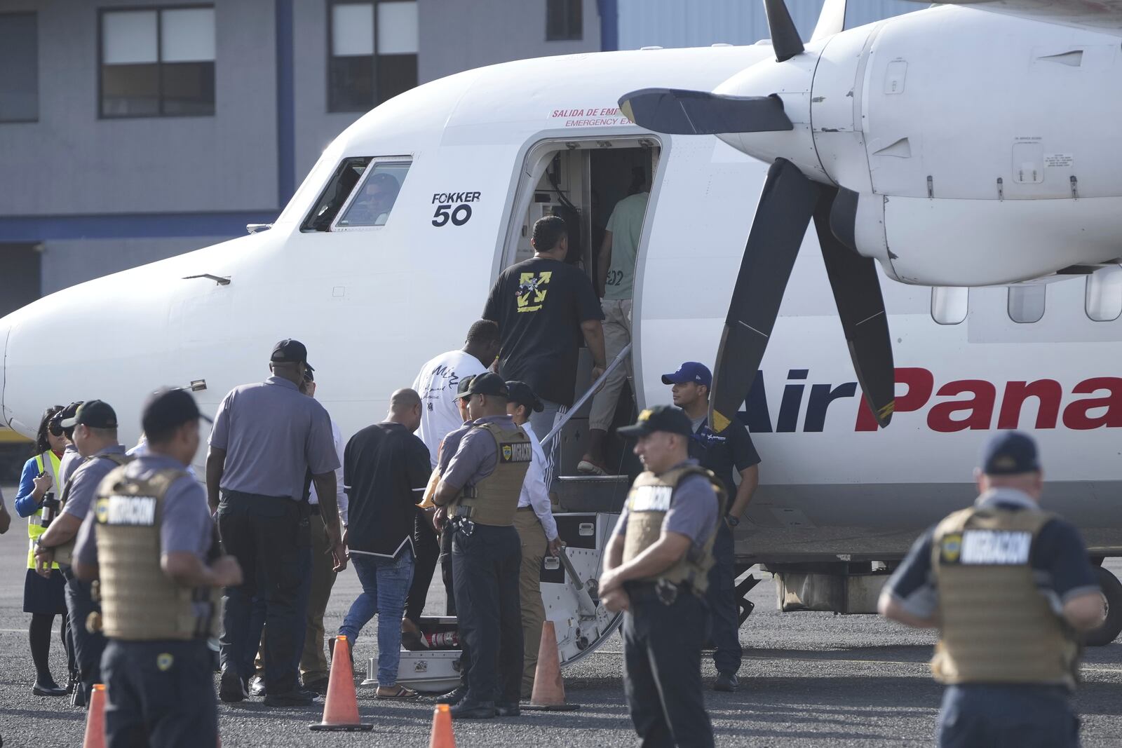 People board a repatriation flight bound for Colombia at Albrook Airport in Panama City, Monday, Feb. 3, 2025. (AP Photo/Mark Schiefelbein, Pool)