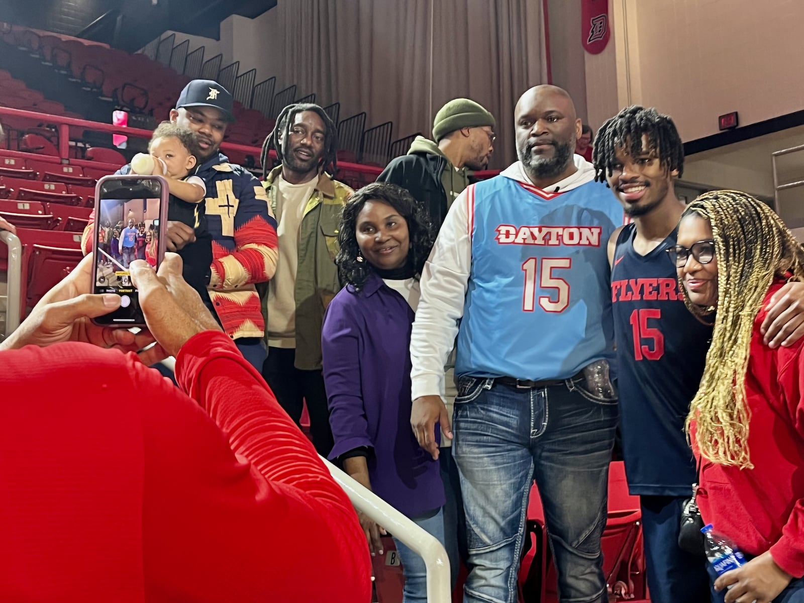 Dayton's DaRon Holmes poses for a photo with family members after a victory against Davidson on Saturday, Dec. 31, 2022, at Belk Arena in Davidson, N.C. David Jablonski/Staff