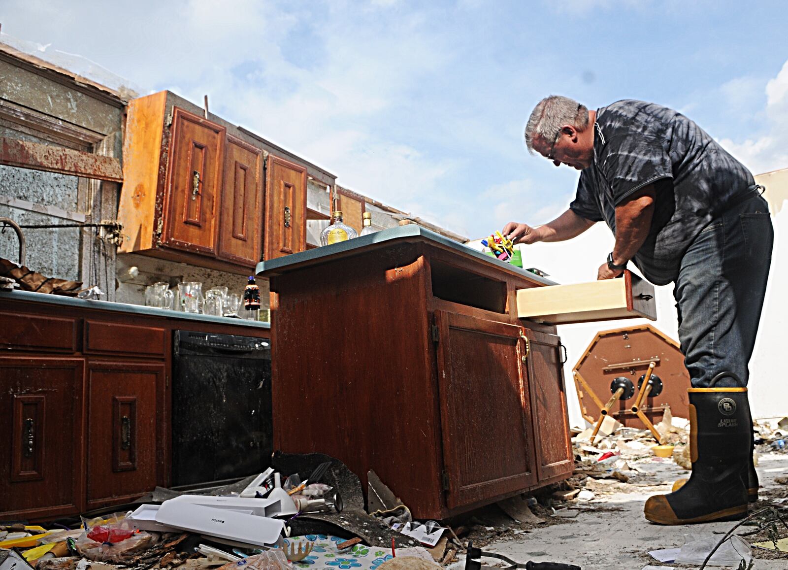 Tim Stine removes items from his kitchen at his home on State Route 571 near West Milton on Wednesday. MARSHALL GORBY/STAFF