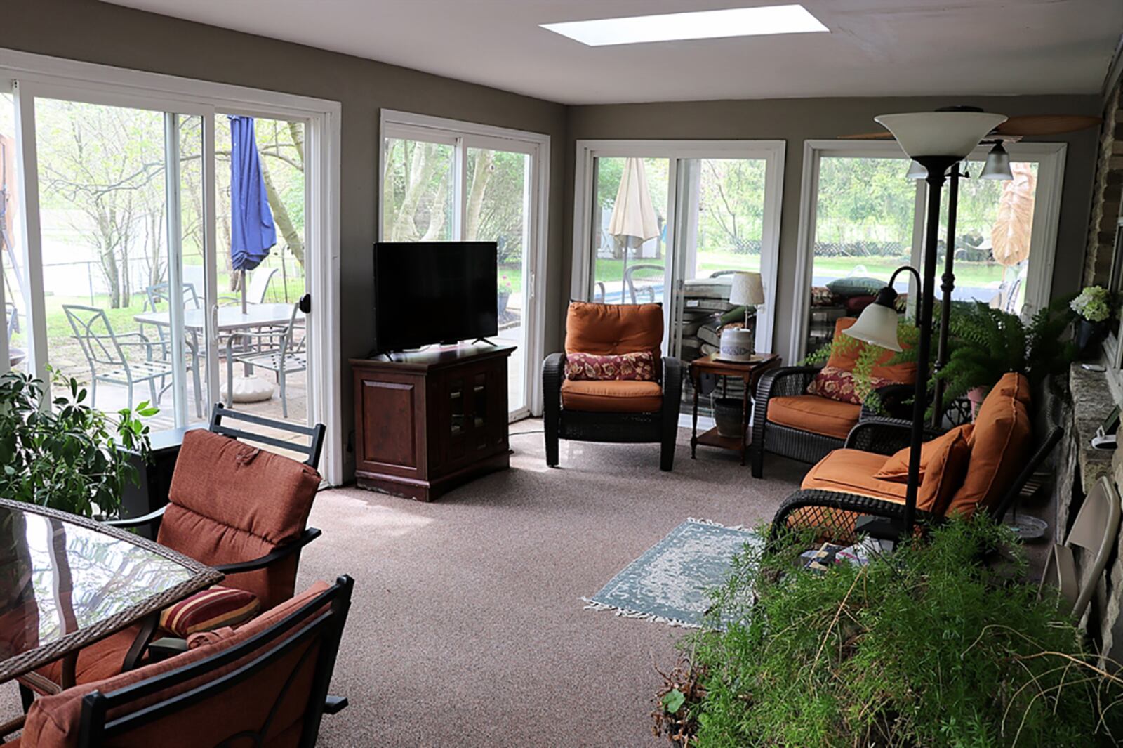 Sliding patio doors open off the breakfast nook out to the 12-by-20-foot, 3-season room. The sun room has several sliding patio doors with screens and two skylights. CONTRIBUTED PHOTO BY KATHY TYLER