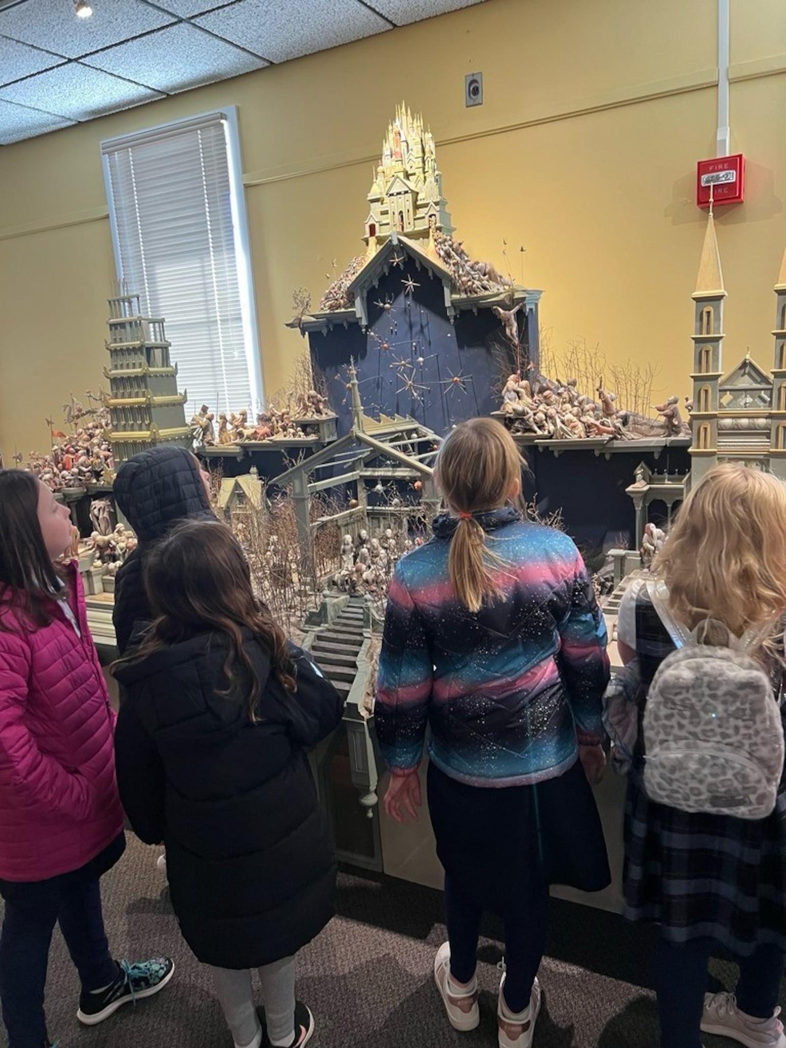 Third-graders from St. Luke admire a Nativity scene at UD. CONTRIBUTED