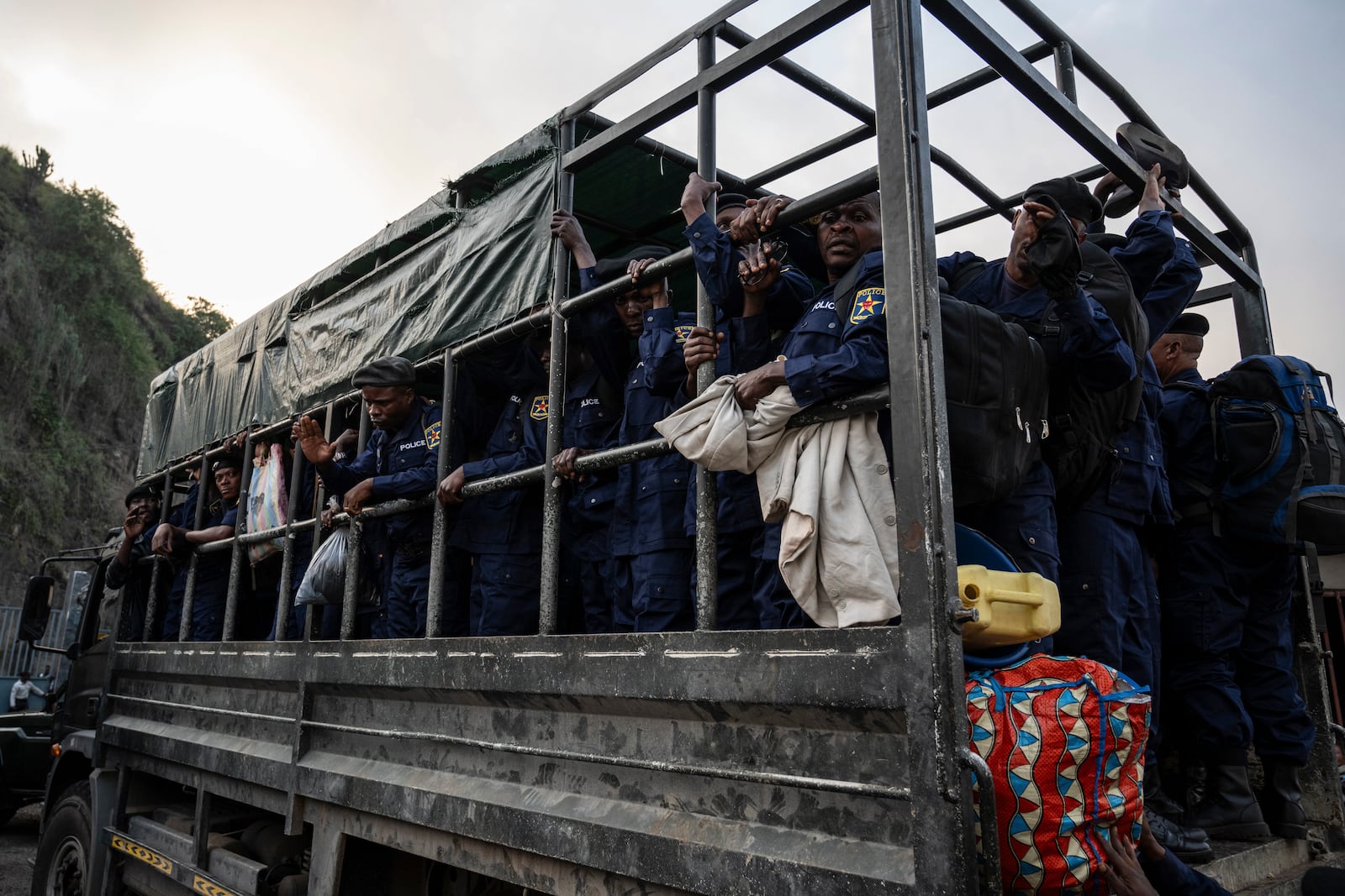 Former members of the Armed Forces of the Democratic Republic of Congo (FARDC) and police officers who allegedly surrendered to M23 rebels arrive in Goma, Congo, Sunday, Feb. 23, 2025. (AP Photo/Moses Sawasawa)