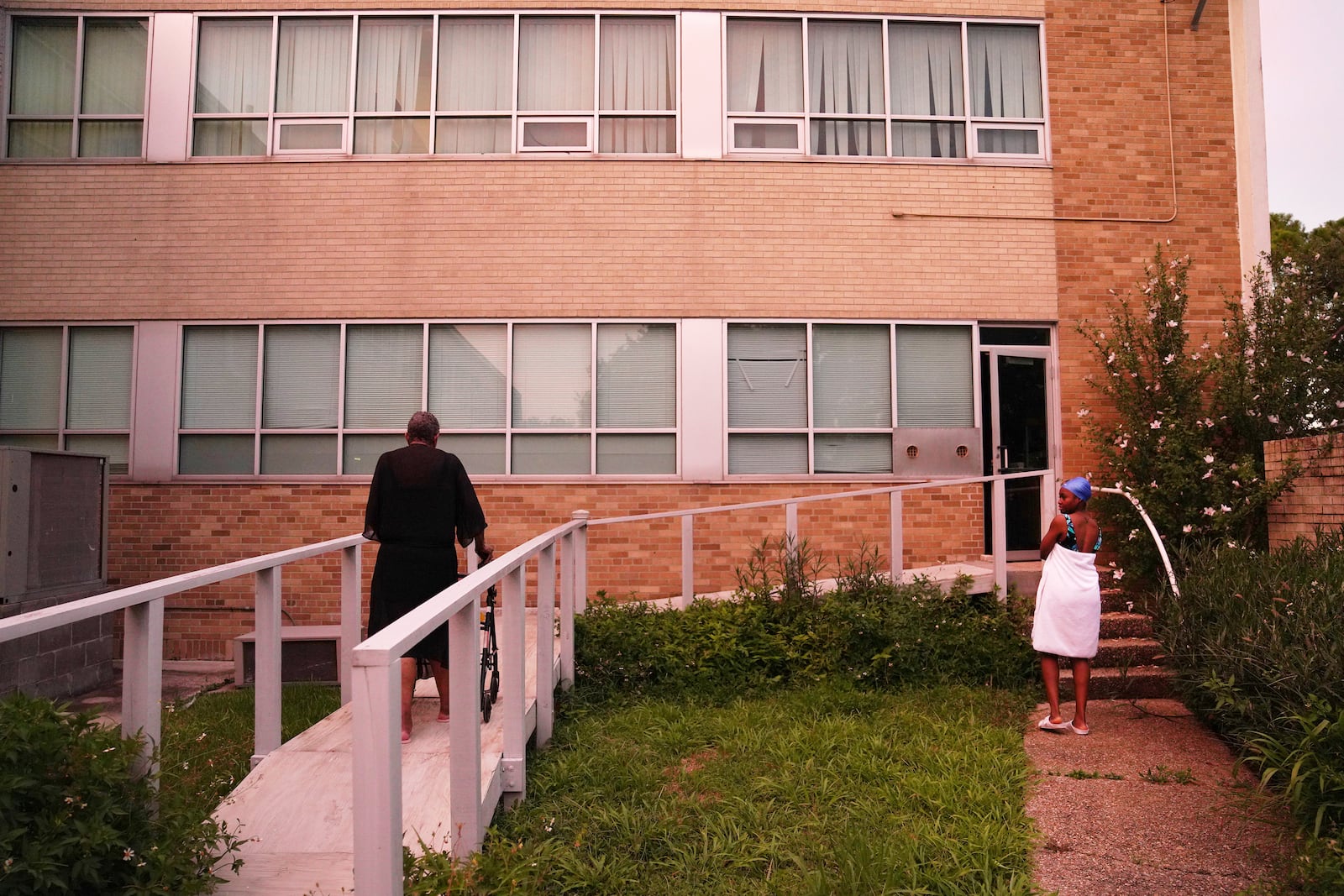 Sister Clara Mae Jackson and Sister Seyram Mary Adzokpa walk back to the motherhouse after a swim at the Sisters of the Holy Family in New Orleans, Tuesday, June 25, 2024. (AP Photo/Jessie Wardarski)