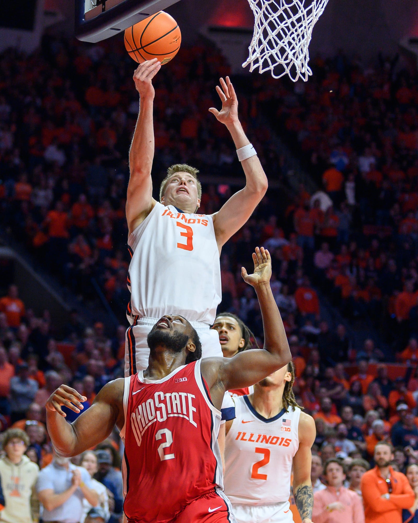 Illinois' Ben Humrichous (3) reaches for a rebound over Ohio State's Bruce Thornton, bottom left, during the second half of an NCAA college basketball game Sunday, Feb. 2, 2025, in Champaign, Ill. (AP Photo/Craig Pessman)