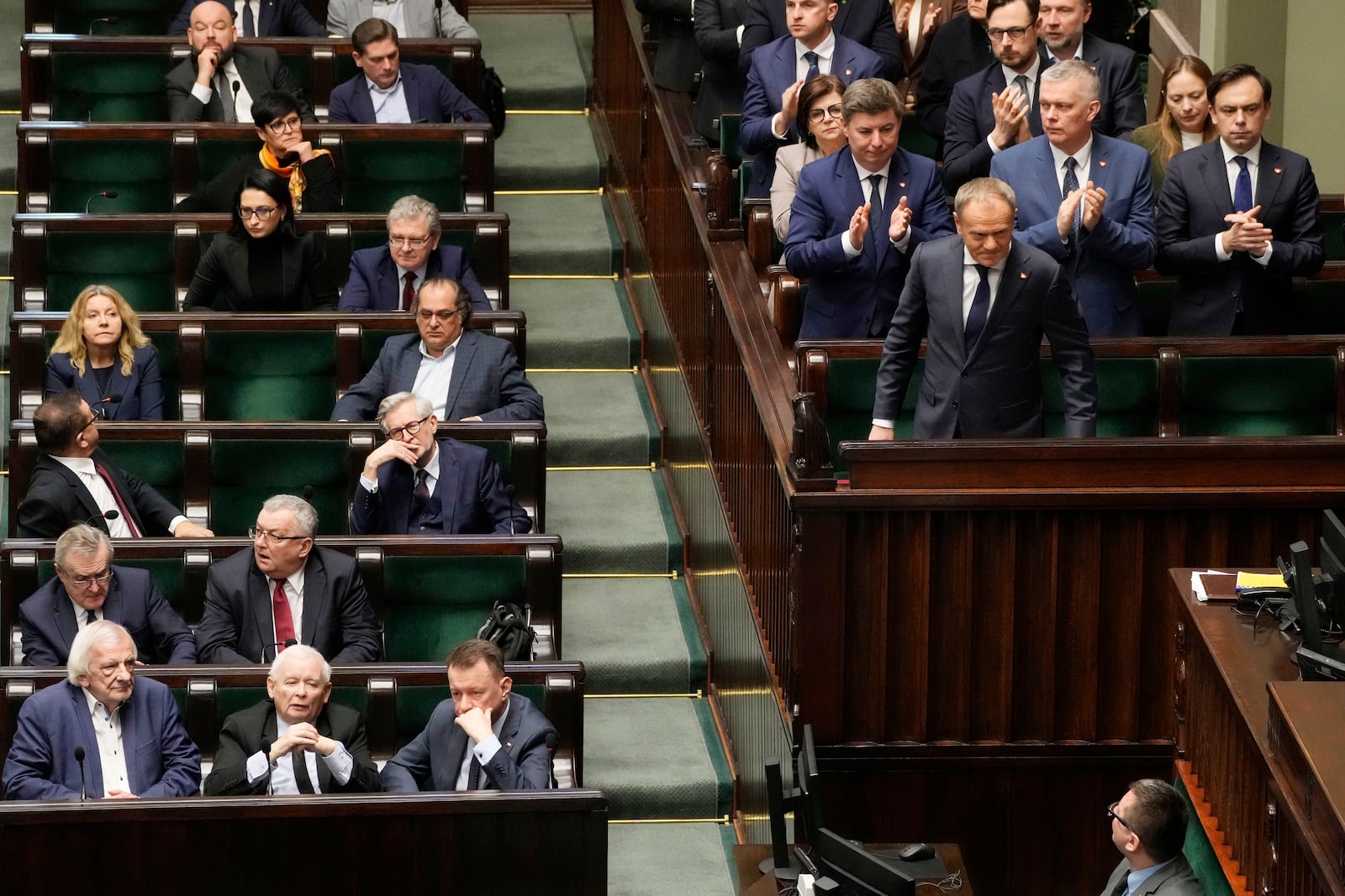 Polish Prime Minister Donald Tusk, right, after speaking at the Sejm, the lower house of parliament, in Warsaw, Poland, Friday March 7, 2025. (AP Photo/Czarek Sokolowski)