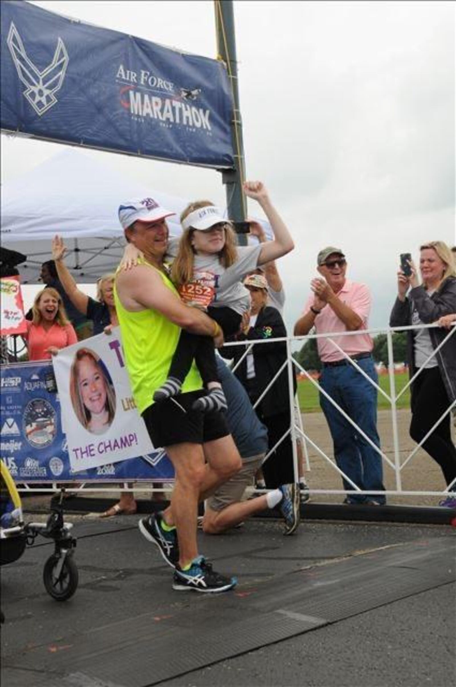 Caleigh Hildebrandt being carried across the finish line at the 2016  US Air Force Marathon by her dad, Randy Hildebrandt, a retired USAF lieutenant colonel. CONTRIBUTED