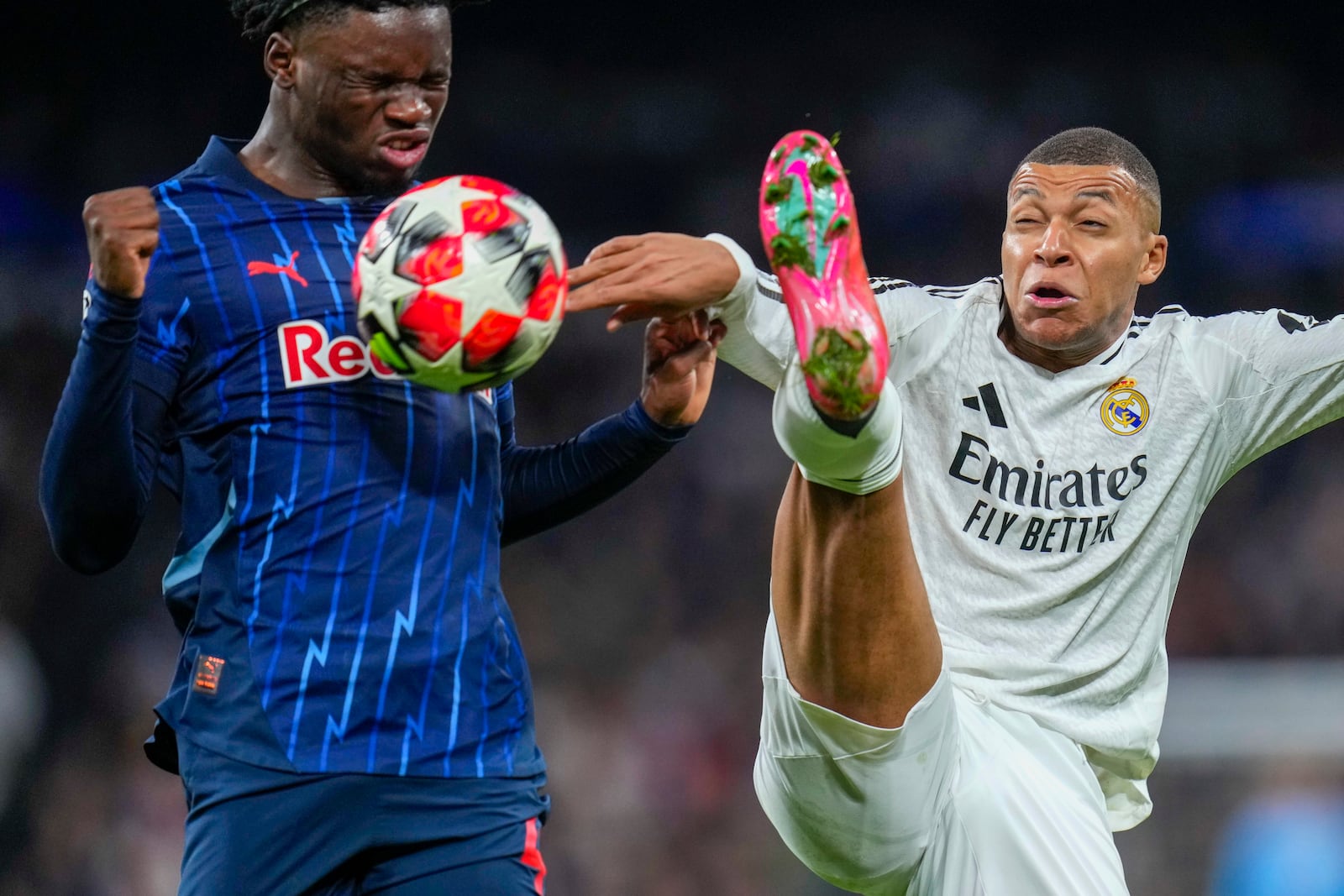 Salzburg's Hendry Blank, left, and Real Madrid's Kylian Mbappe vie for the ball during the Champions League opening phase soccer match between Real Madrid and FC Salzburg at the Santiago Bernabeu stadium in Madrid, Wednesday, Jan. 22, 2025. (AP Photo/Manu Fernandez)