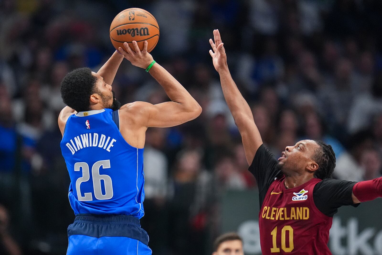 Dallas Mavericks guard Spencer Dinwiddie (26) shoots against Cleveland Cavaliers guard Darius Garland (10) during the first half of an NBA basketball game, Friday, Jan. 3, 2025, in Dallas. (AP Photo/Julio Cortez)