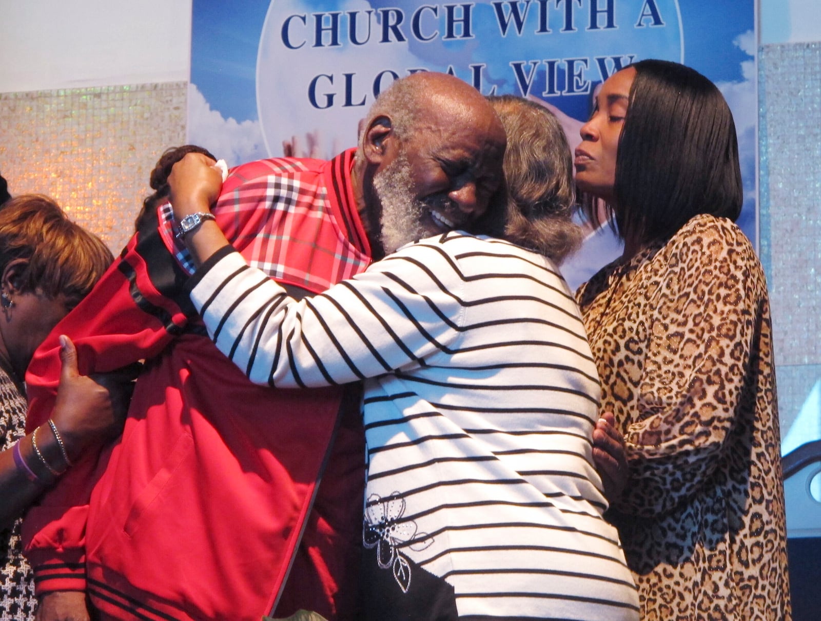 Wilbert Gardner, left, hugs Katrena Alexander while Alexander's daughter, Regina Brinson, right, looks on during a news conference Tuesday, Oct. 22, 2024, in Jacksonville, Fla, A dock gangway collapse happened as people were leaving a cultural festival on Sapelo Island, Georgia, on Saturday, Oct. 19, 2024. Alexander's brother, Isaiah Thomas, was among the dead. Gardner had a friend who was hospitalized with injuries. (AP Photo/Russ Bynum)