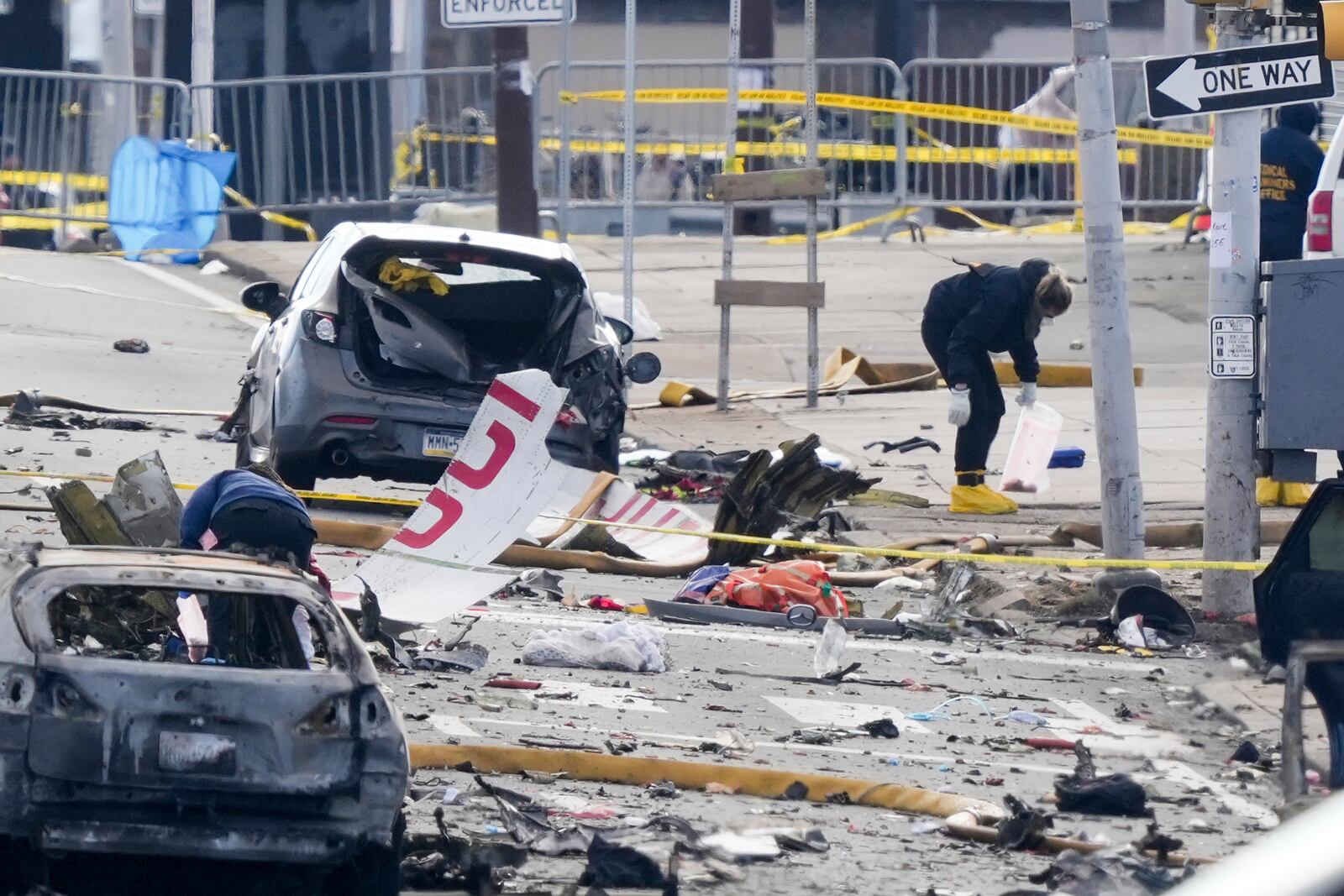 Investigators work the scene after a small plane crashed in Philadelphia, Saturday, Feb. 1, 2025. (AP Photo/Matt Rourke)