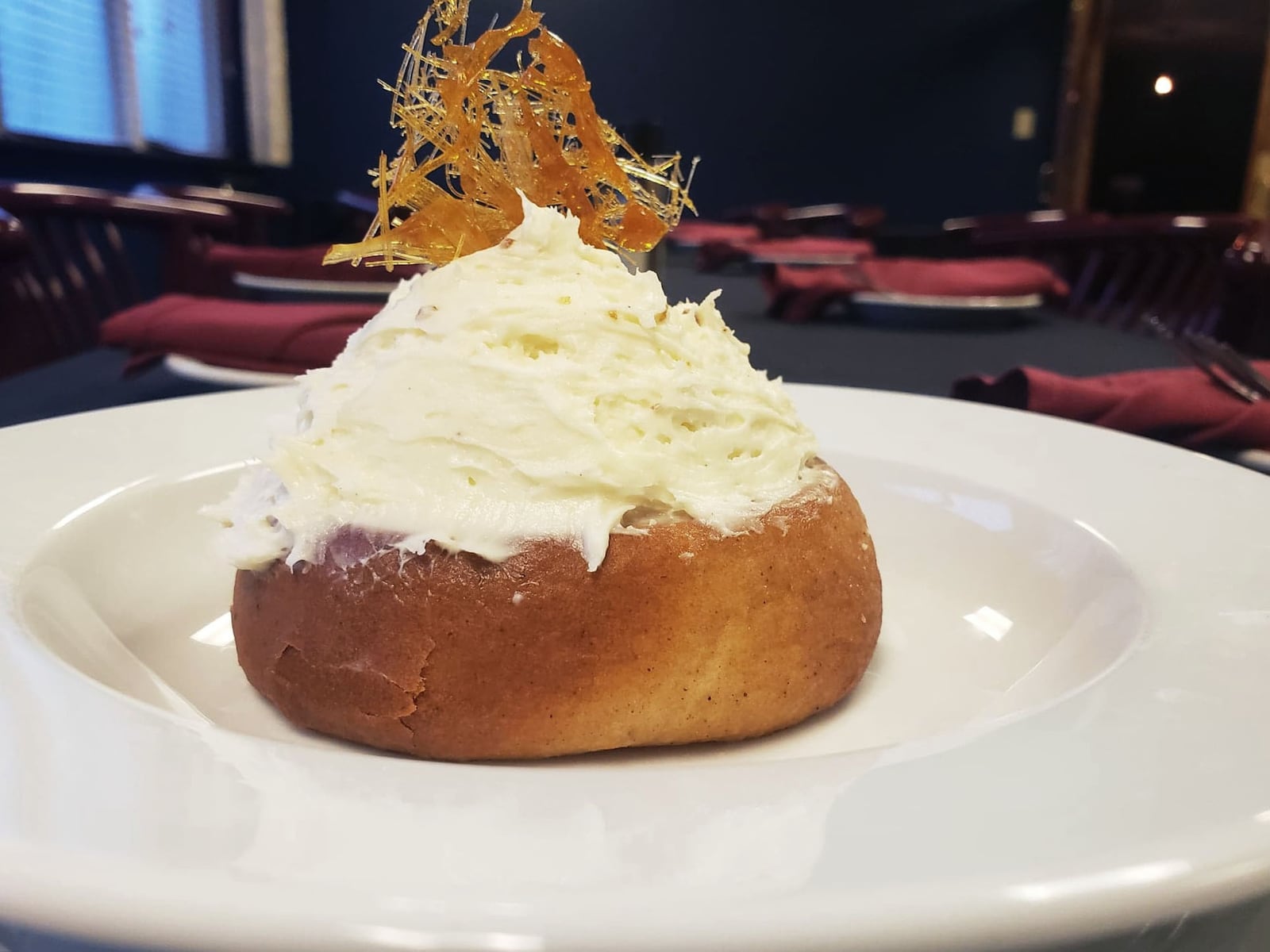 The Holy Moley Cinnamon Rolley is one of the desserts offered on The Bison & The Boar's new comfort food menu. It is a house made cinnamon roll, baked fresh and served hot, topped with whipped cream cheese frosting and garnished with spun sugar. CONTRIBUTED