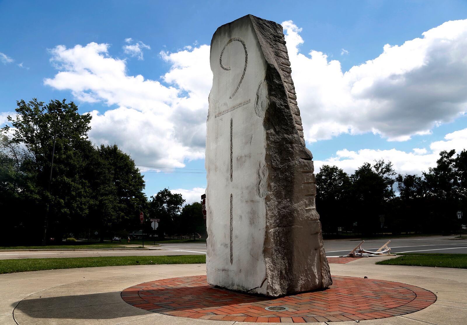 "Memorial for 9/11," a sculpture by artist John Van Alstine, is the centerpiece of Seitz Plaza in Kettering's Lincoln Park. The 26,000 pound sculpture is made of Indiana limestone and is designed to be a spot of contemplation as well as a solar calendar. The noon sun aligns with a stylus on one side of the monument on Sept. 11 of each year. LISA POWELL / STAFF