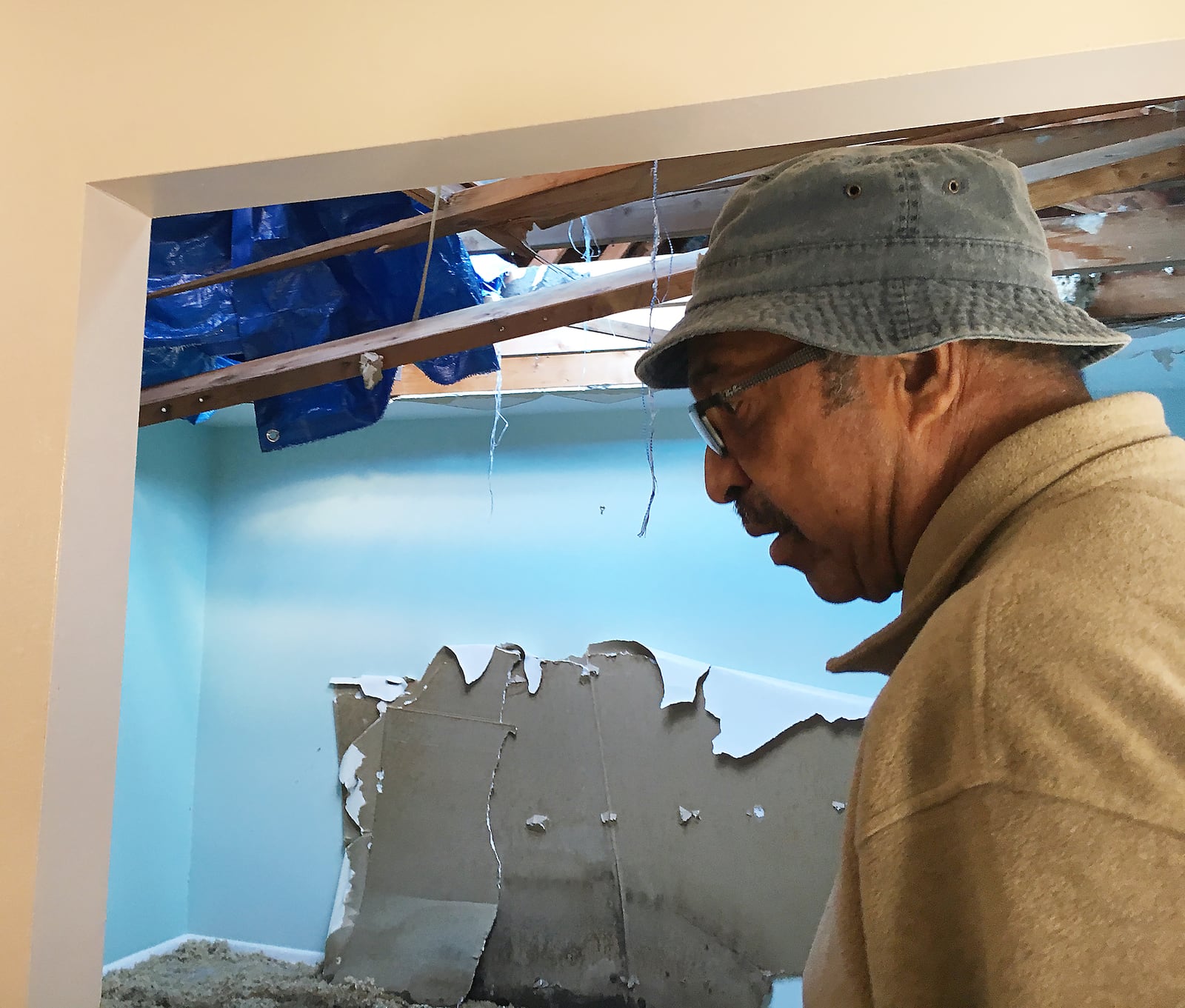 Willie Dunford walks through his sister Lovie's house in Trotwood, where a hole in the roof is still open to the sky five months after the city was hit with an EF4 tornado.