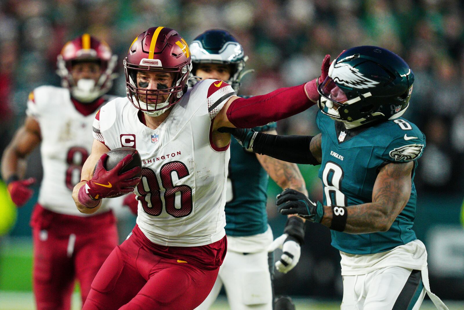 Washington Commanders tight end Zach Ertz (86) stiff arms Philadelphia Eagles safety C.J. Gardner-Johnson (8) during the second half of the NFC Championship NFL football game, Sunday, Jan. 26, 2025, in Philadelphia. (AP Photo/Derik Hamilton)