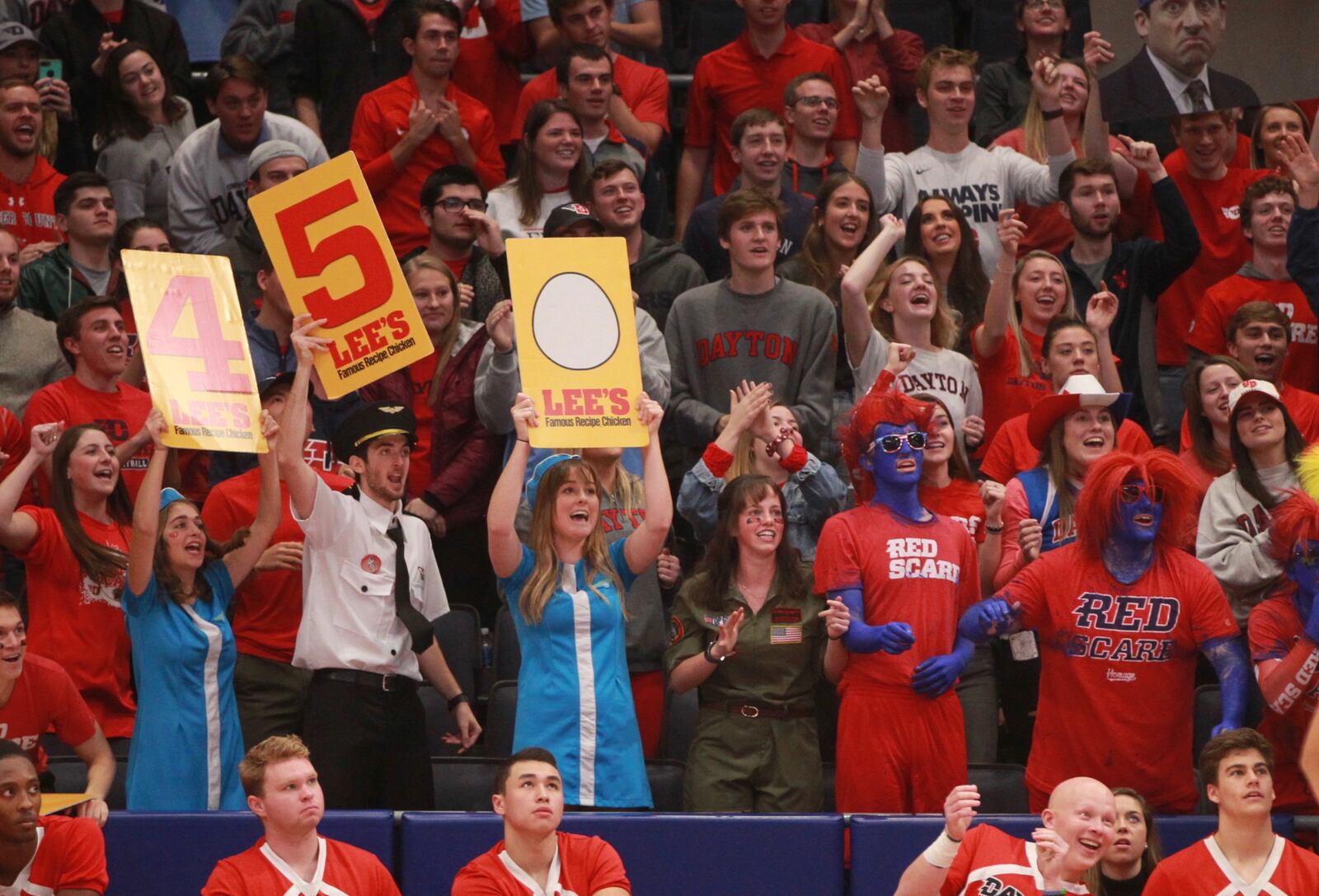 Fans in the Red Scare section cheer during a game against Omaha on Tuesday, Nov. 19, 2019, at UD Arena. Among the students is Emily Noll, who's in the center wearing the flight attendant uniform.