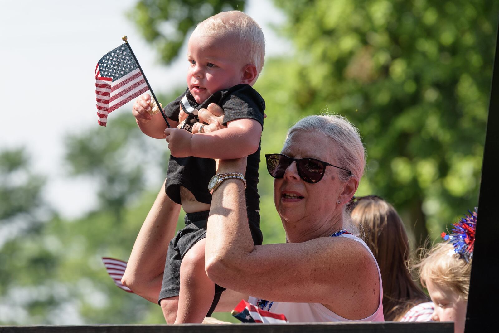 Centerville-Washington Twp. Americana Festival parade watchers try for a better look at the Uptown Centerville festivities Tuesday, July 4, 2023. The festival, which got its start in 1972, attracts more than 85,000 visitors annually. TOM GILLIAM/CONTRIBUTING PHOTOGRAPHER